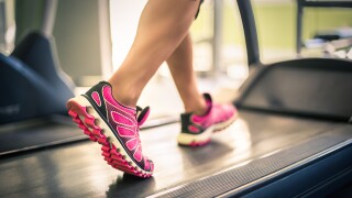 Fitness,Girl,Running,On,Treadmill.,Woman,With,Muscular,Legs,In